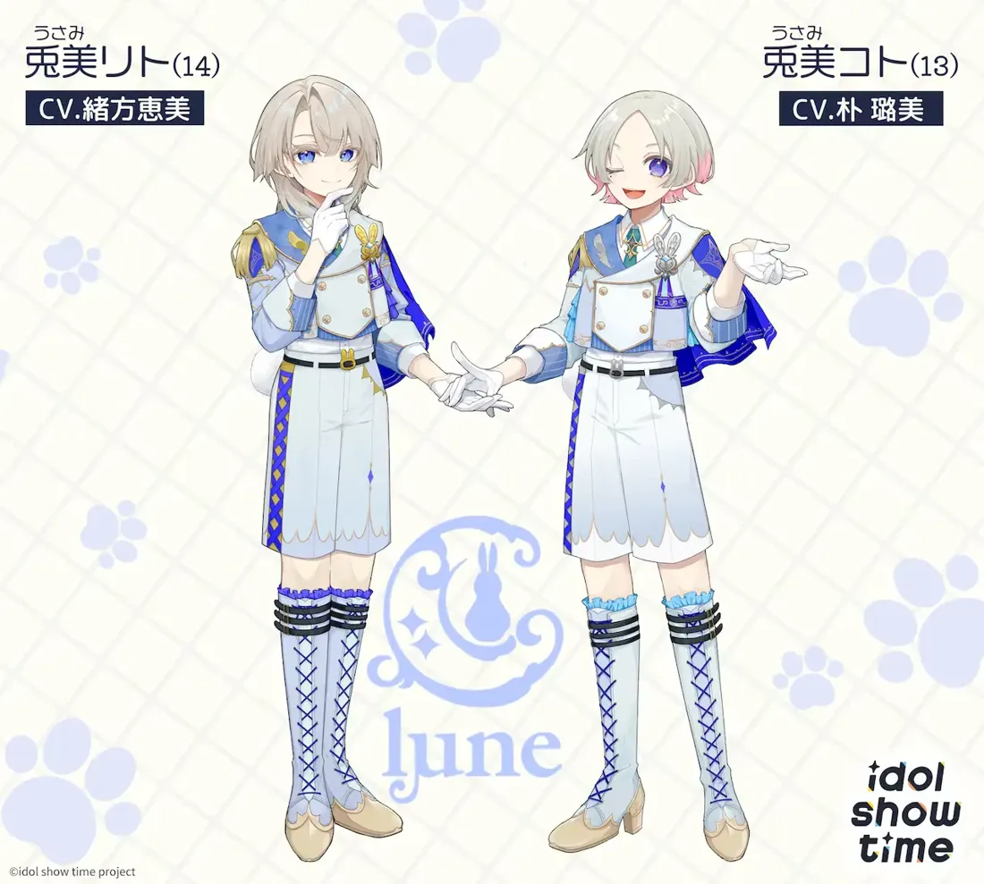 Promotional artwork for the Idol Show Time project, featuring two anime-style male characters, Usumi Rito and Usumi Koto. Rito, on the left, has shoulder-length light grey hair and is wearing a light blue and white officer-style uniform with gold accents, including knee-high laced boots. He is holding his hands together delicately. Koto, on the right, has shorter grey hair with pink highlights and a similar light blue and white uniform; he also wears knee-high laced boots, but is shown with a slightly more playful, open hand gesture. Both characters have pale skin and are presented in a light, pastel colour palette. The background features a pale grid pattern with stylized paw prints. A stylized logo featuring a rabbit and crescent moon with the word 'lune' is in the center. Text in Japanese provides character names, ages (14 and 13), and voice actors. The overall style is reminiscent of anime character design, clean and appealing to a younger audience.